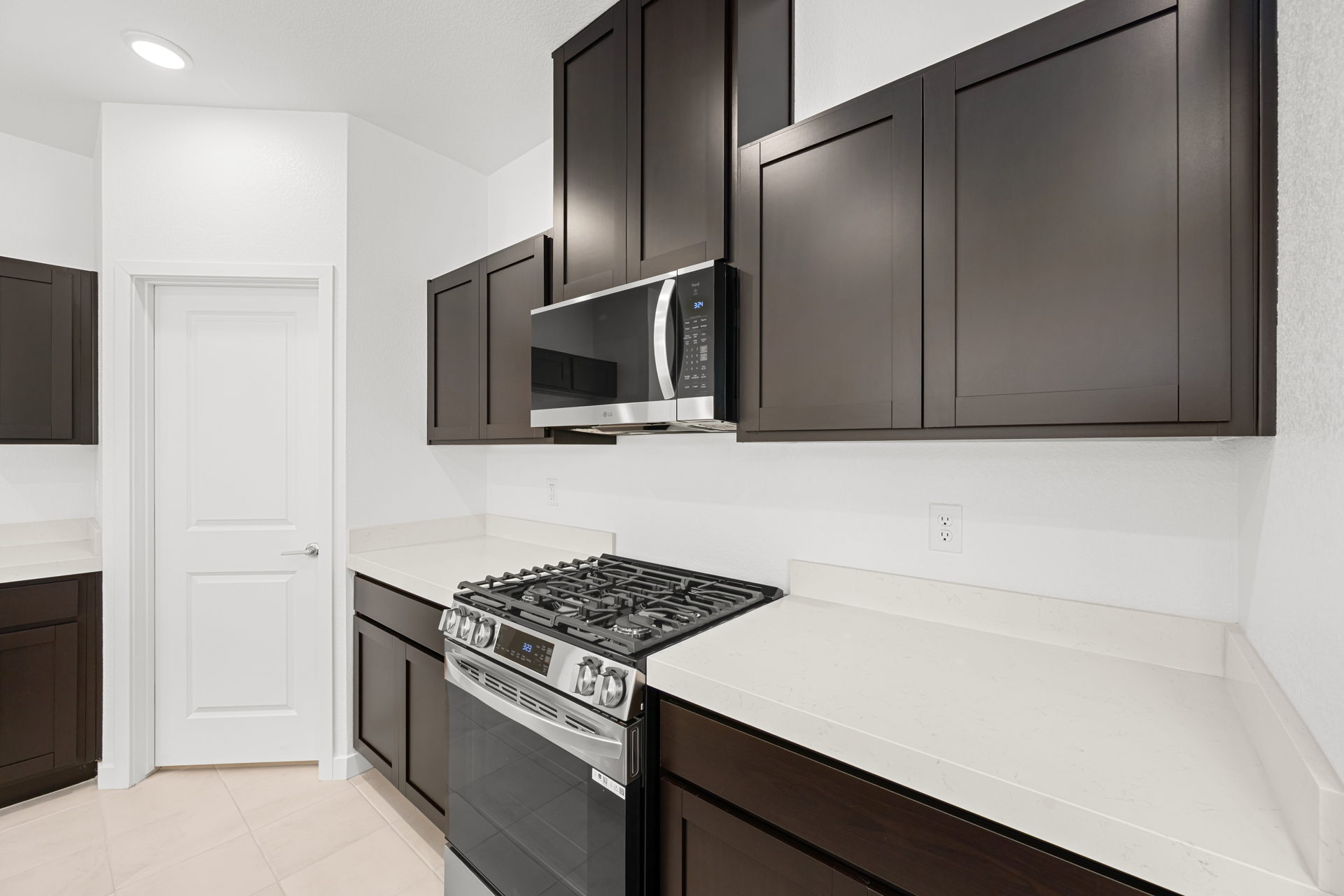 A kitchen with black cabinets.