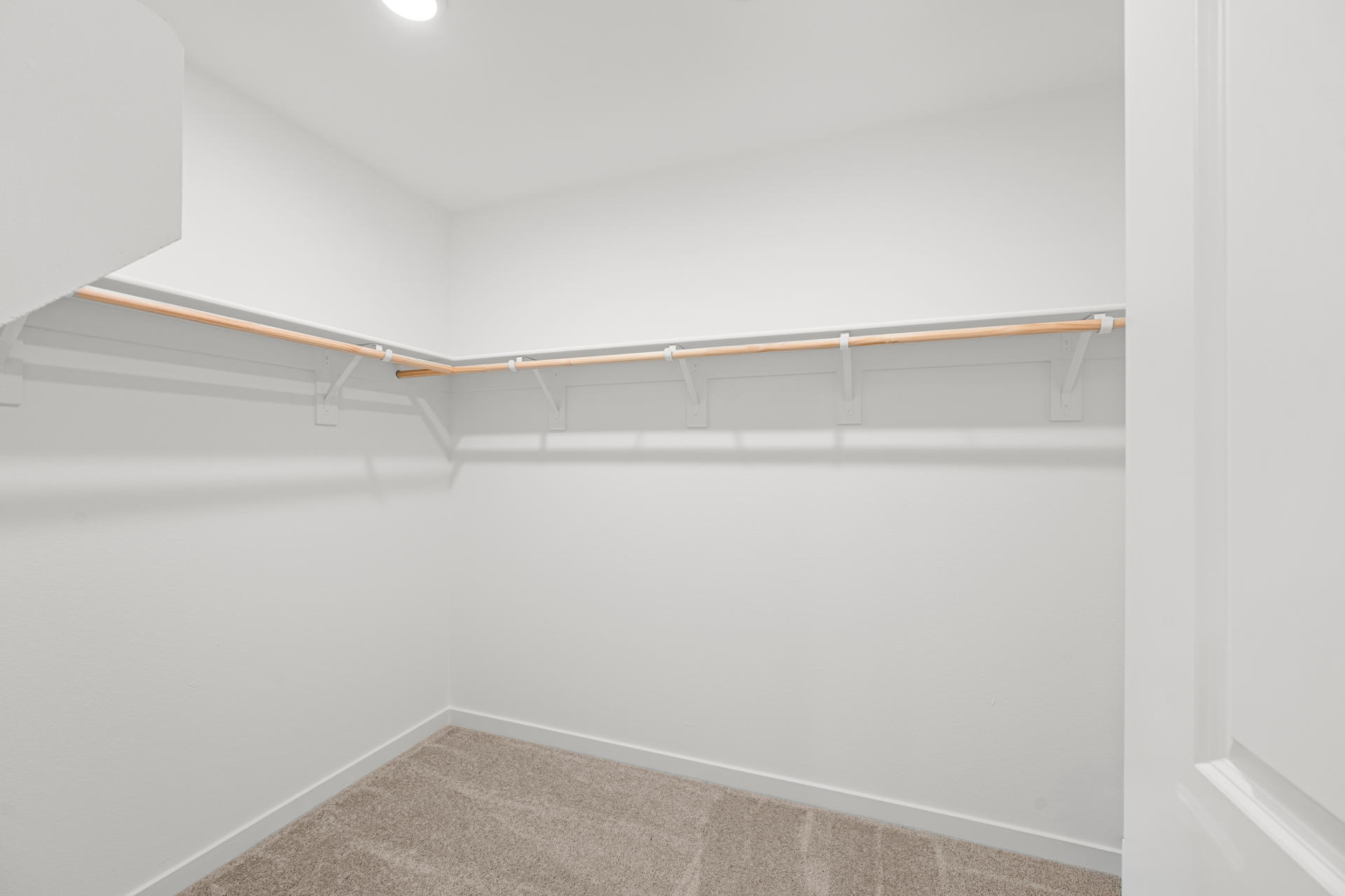 A white wall with a wooden railing.