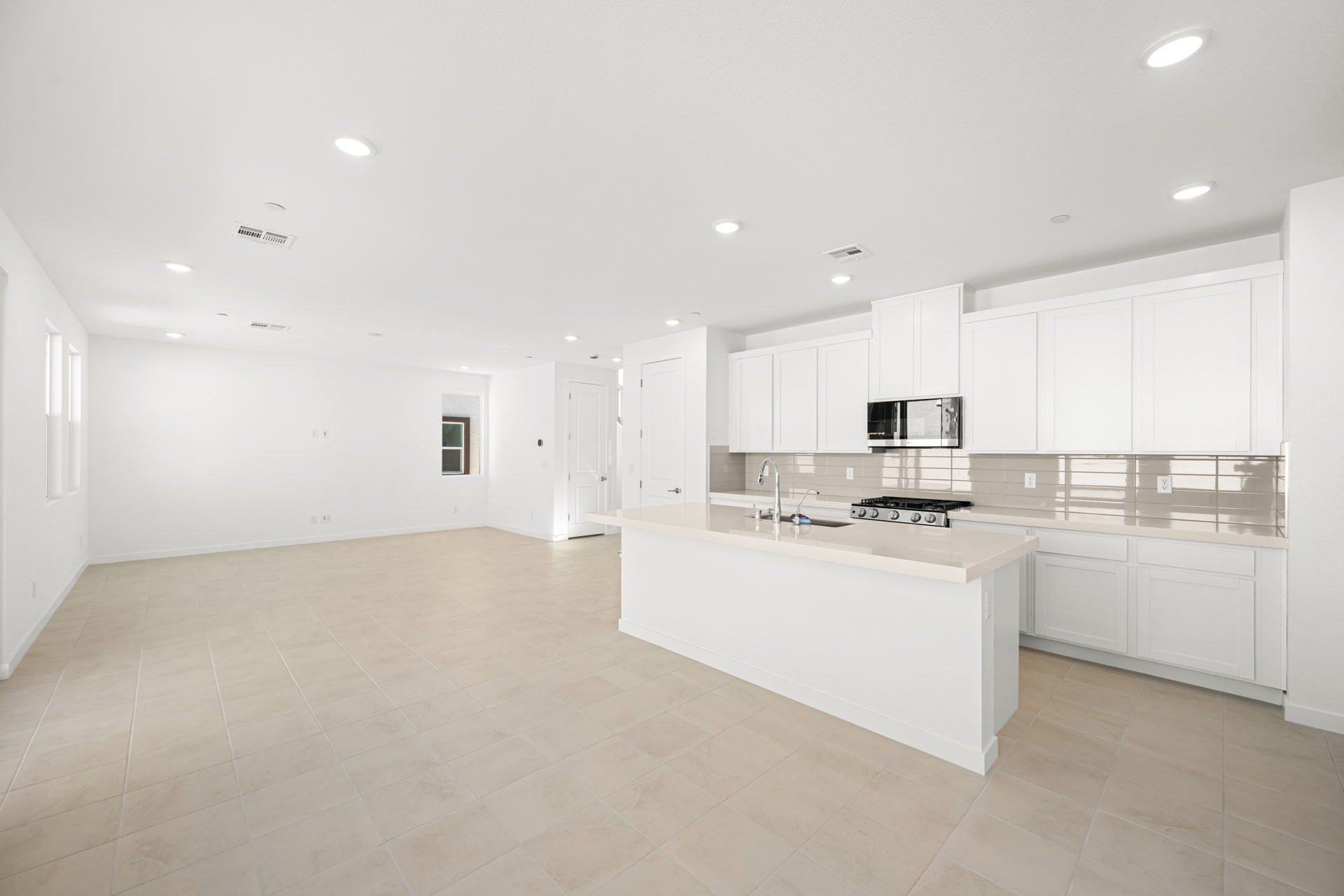 A large kitchen with white cabinets.