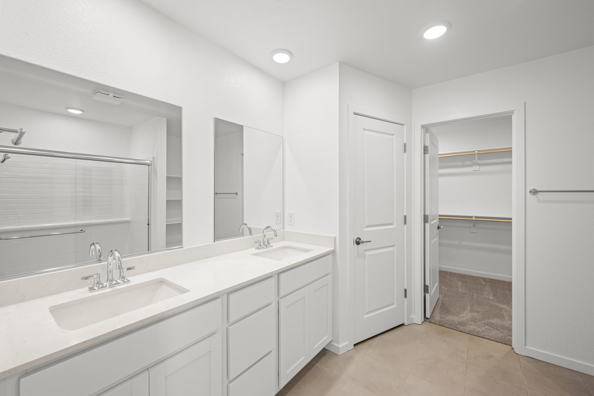 A bathroom with white cabinets.