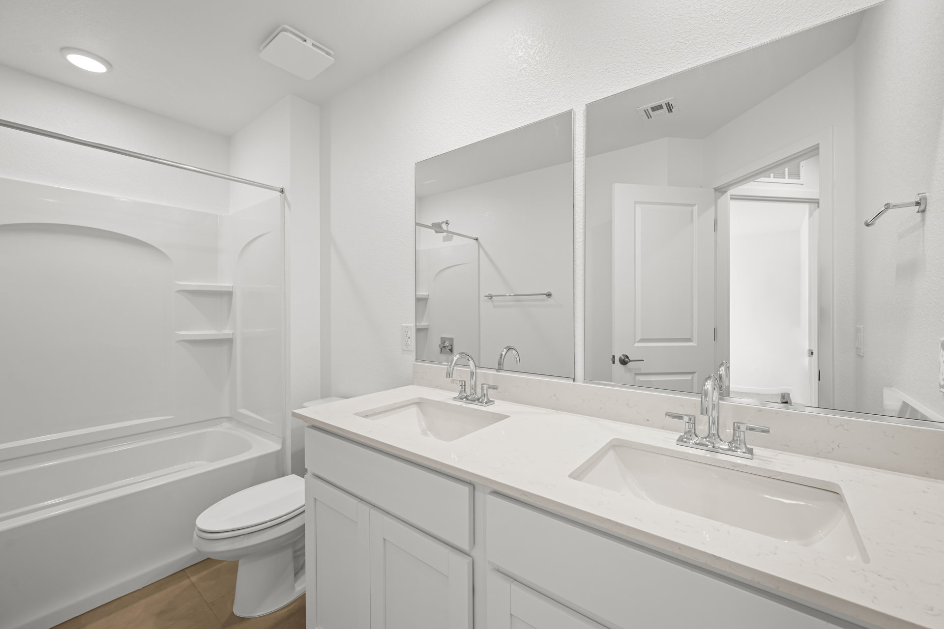 A bathroom with a large mirror.