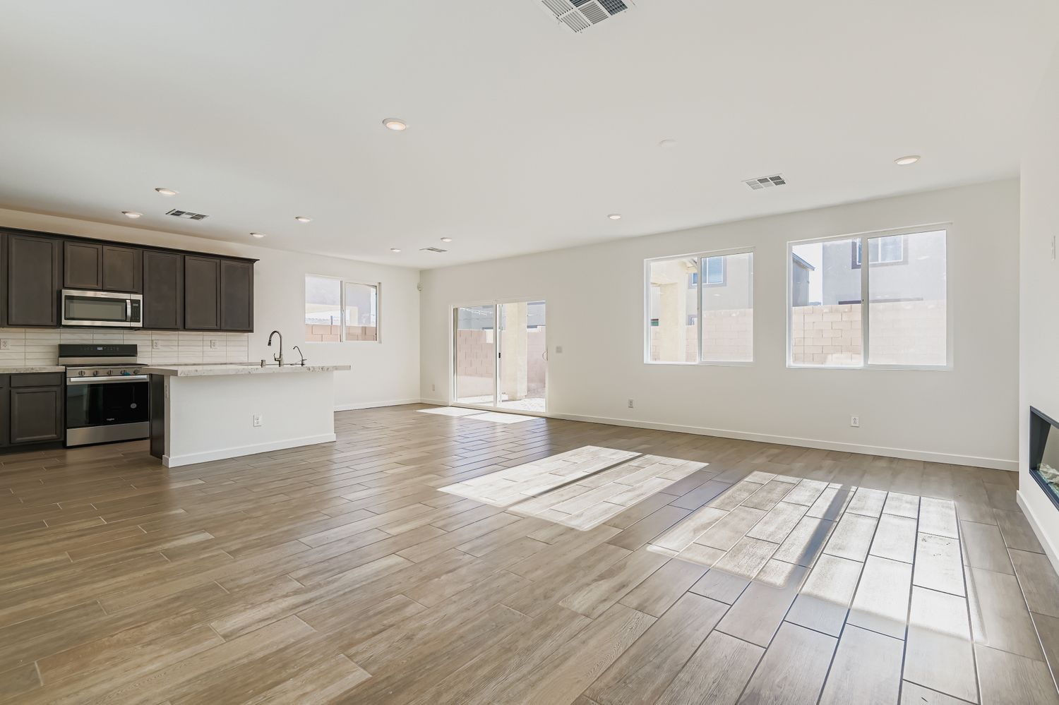 A large kitchen with a wood floor.