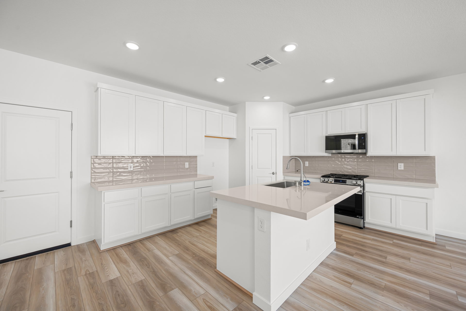 A kitchen with white cabinets.
