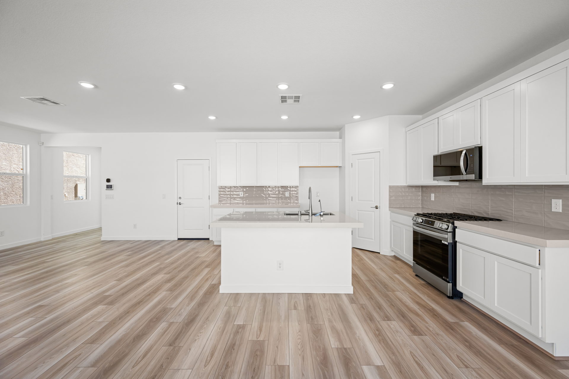 A kitchen with white cabinets.