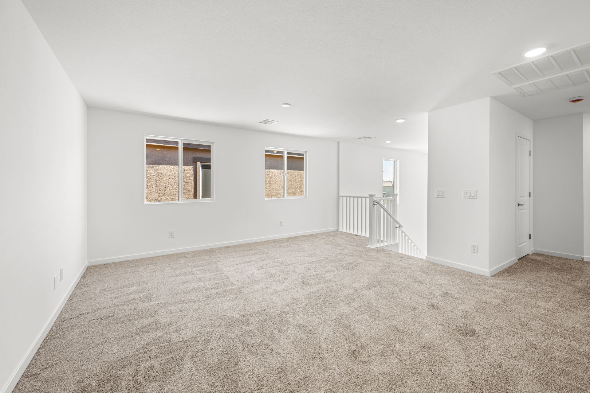 A room with white walls and a carpeted floor.
