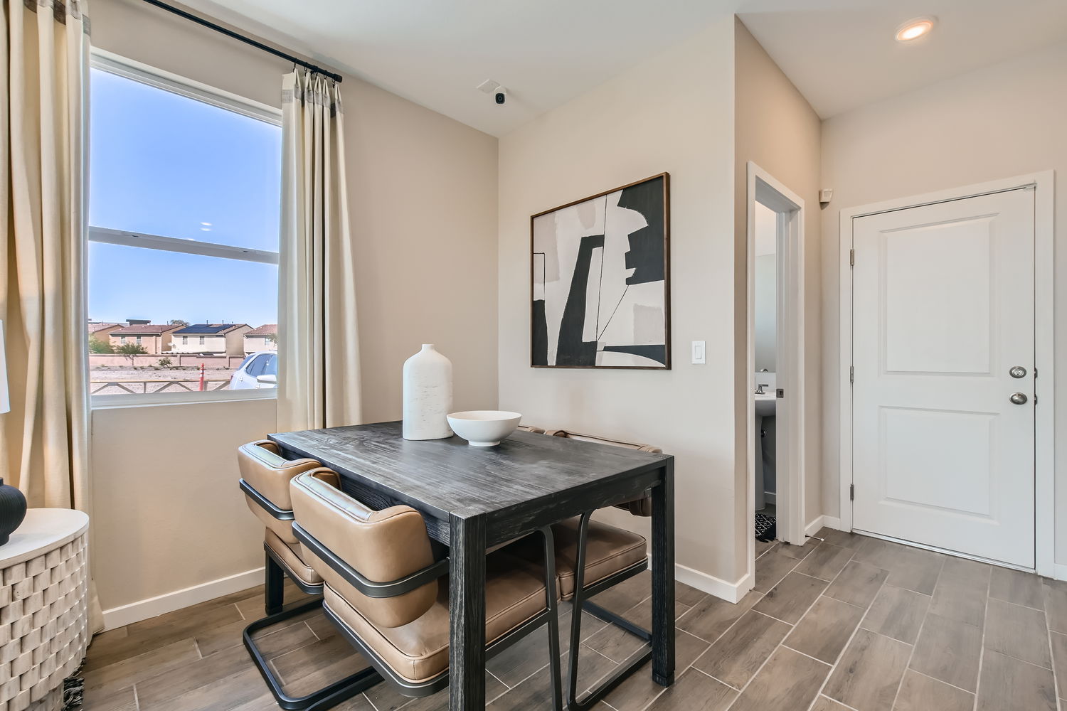 A dining room table with a vase on it.