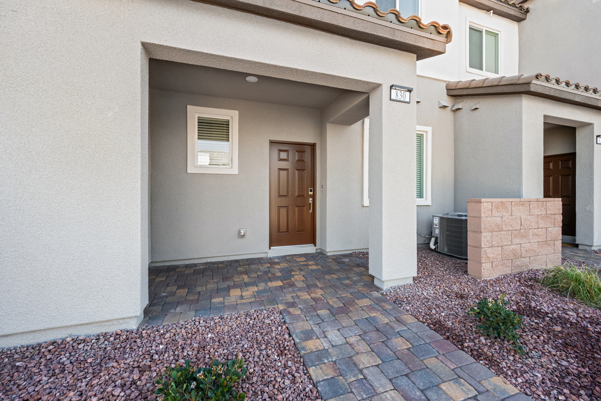 A house with a brick driveway.