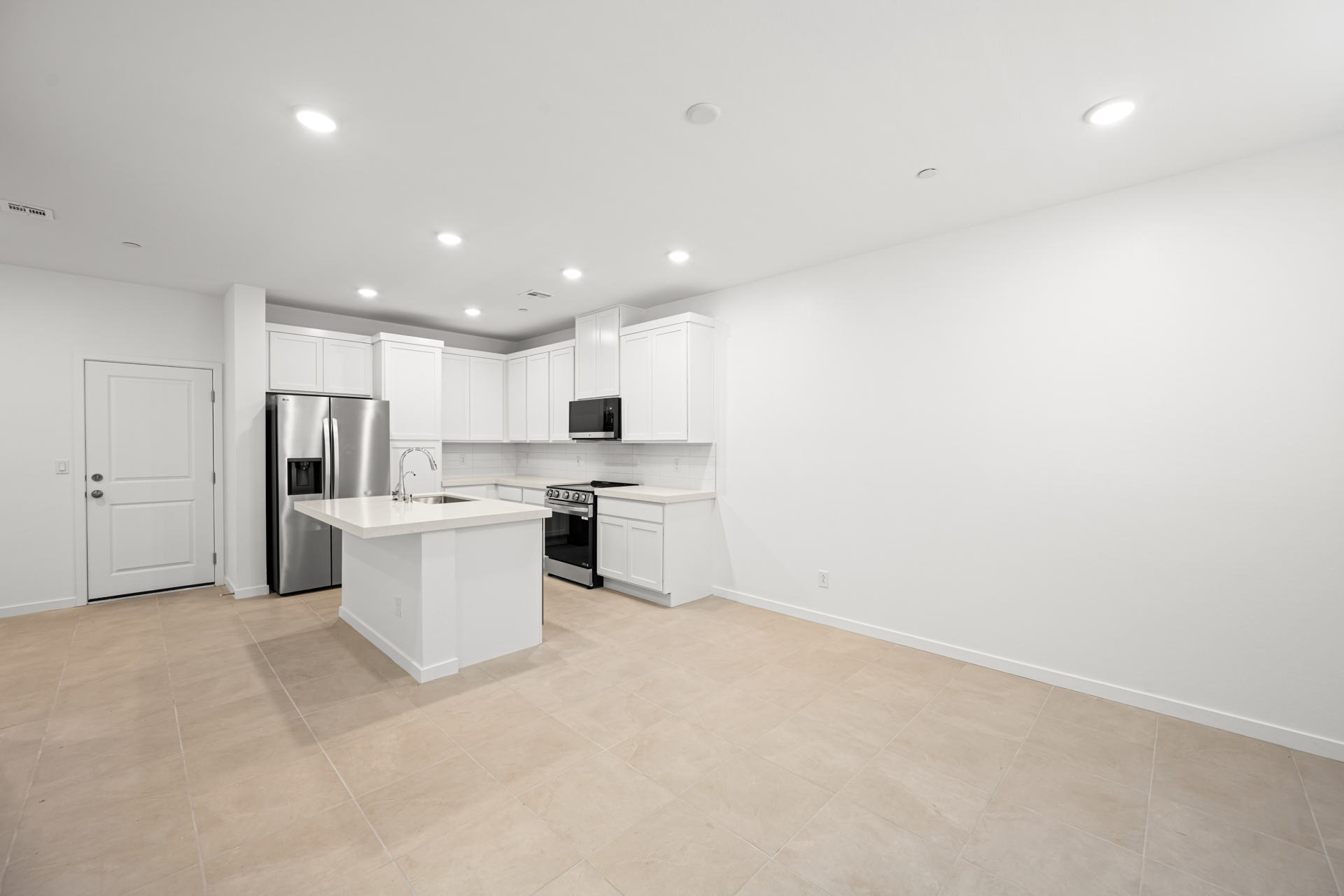 A kitchen with white cabinets.