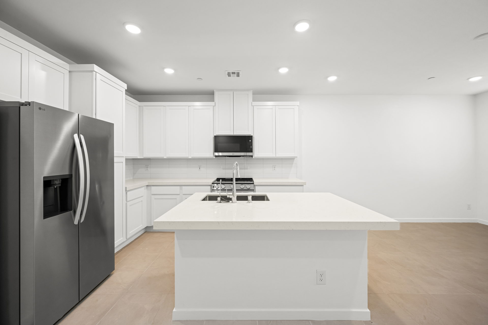 A kitchen with white cabinets.