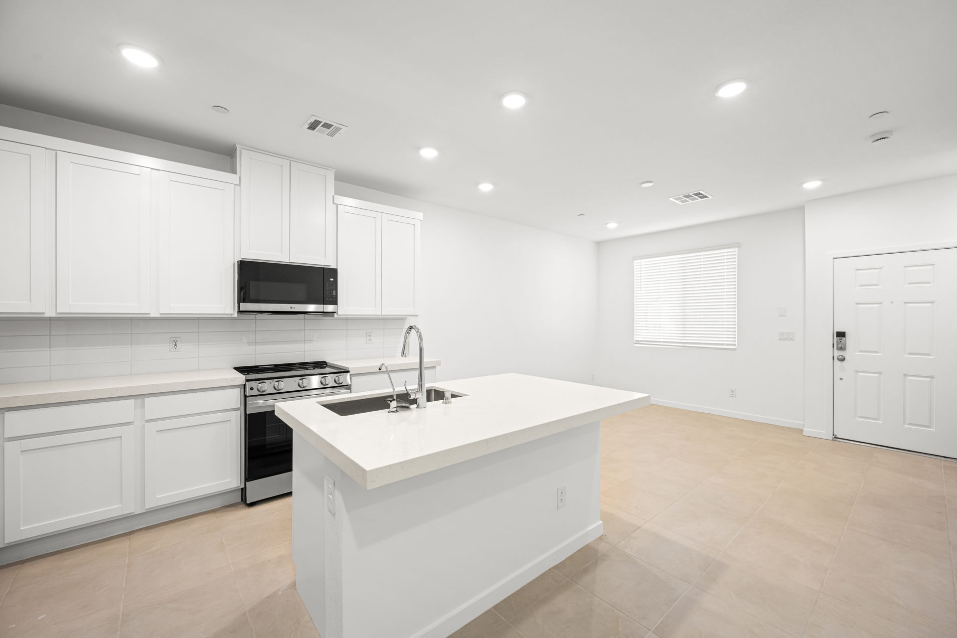 A kitchen with white cabinets.