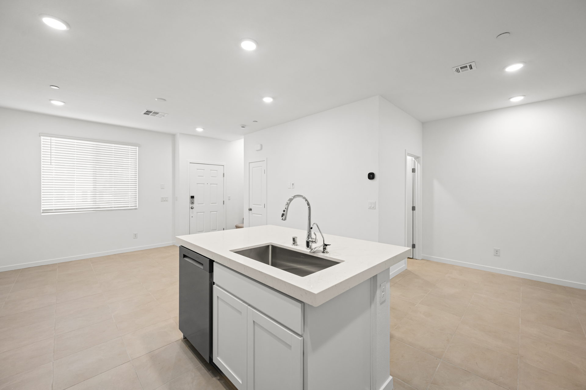 A kitchen with white cabinets.