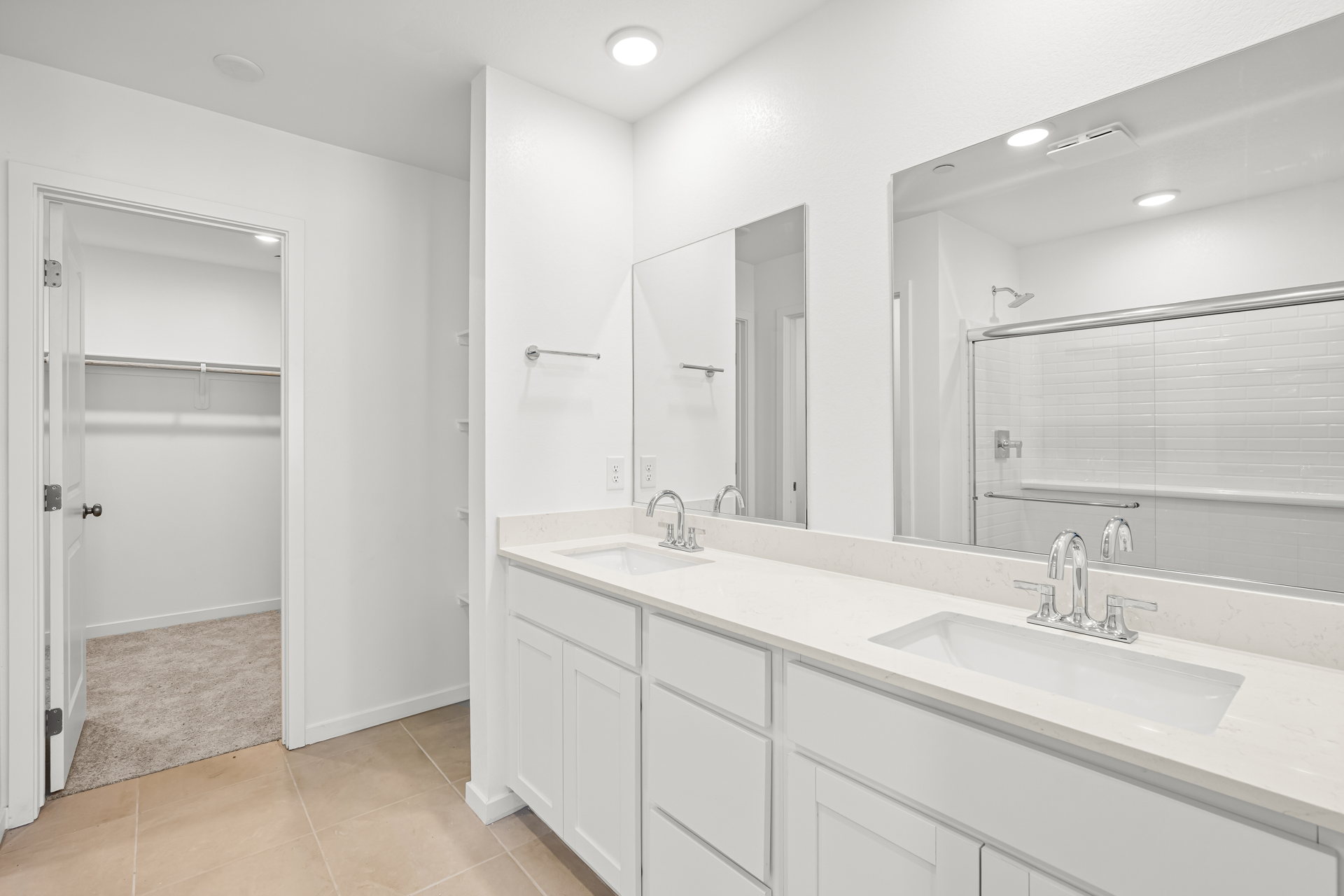 A bathroom with a large mirror.
