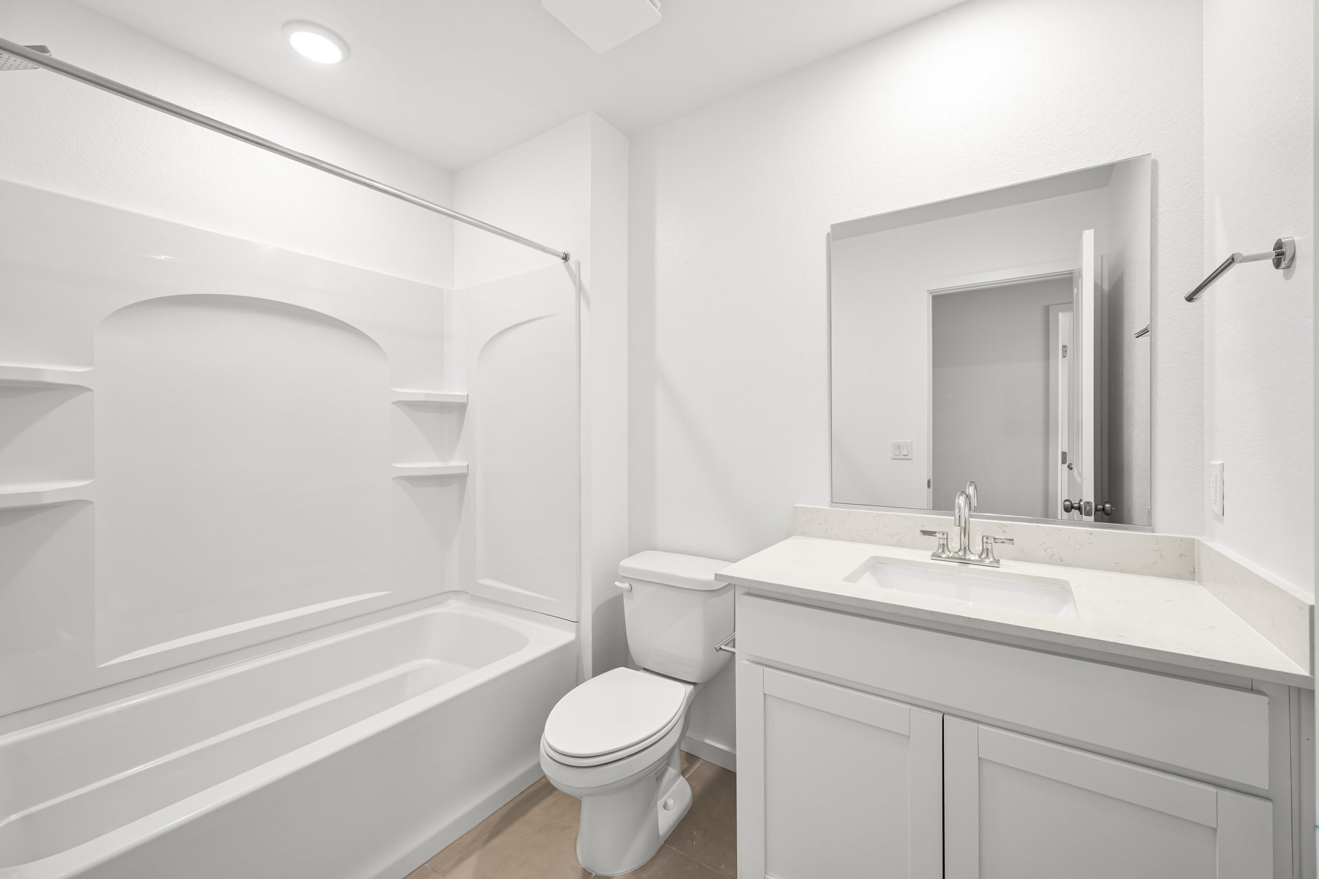 A bathroom with a tub sink and toilet.