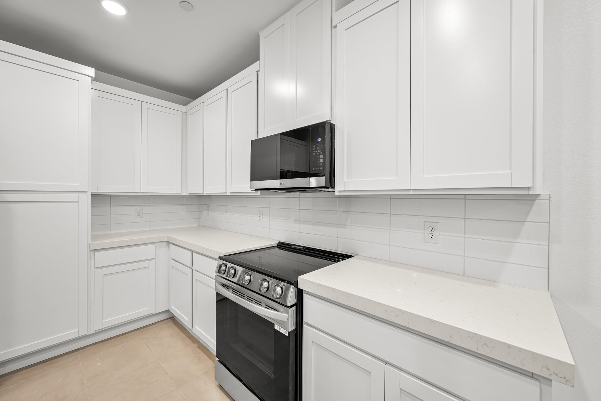 A kitchen with white cabinets.