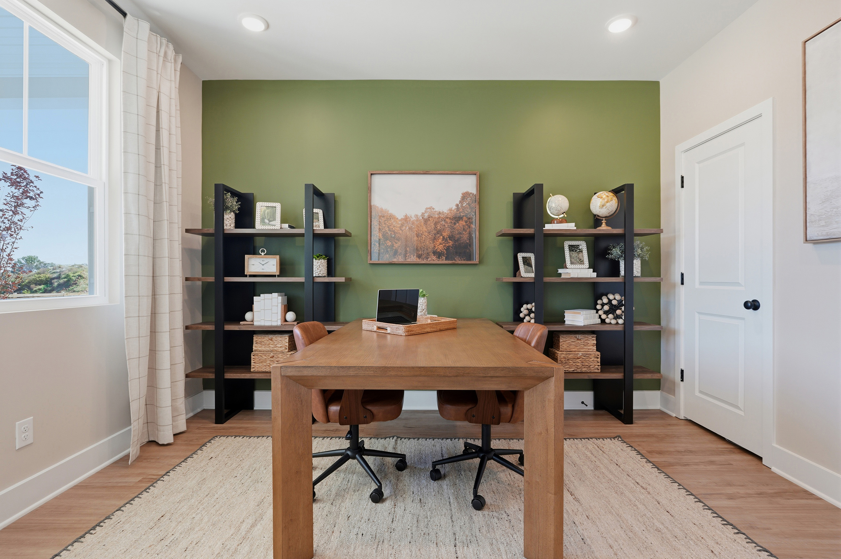 A room with a desk and shelves.