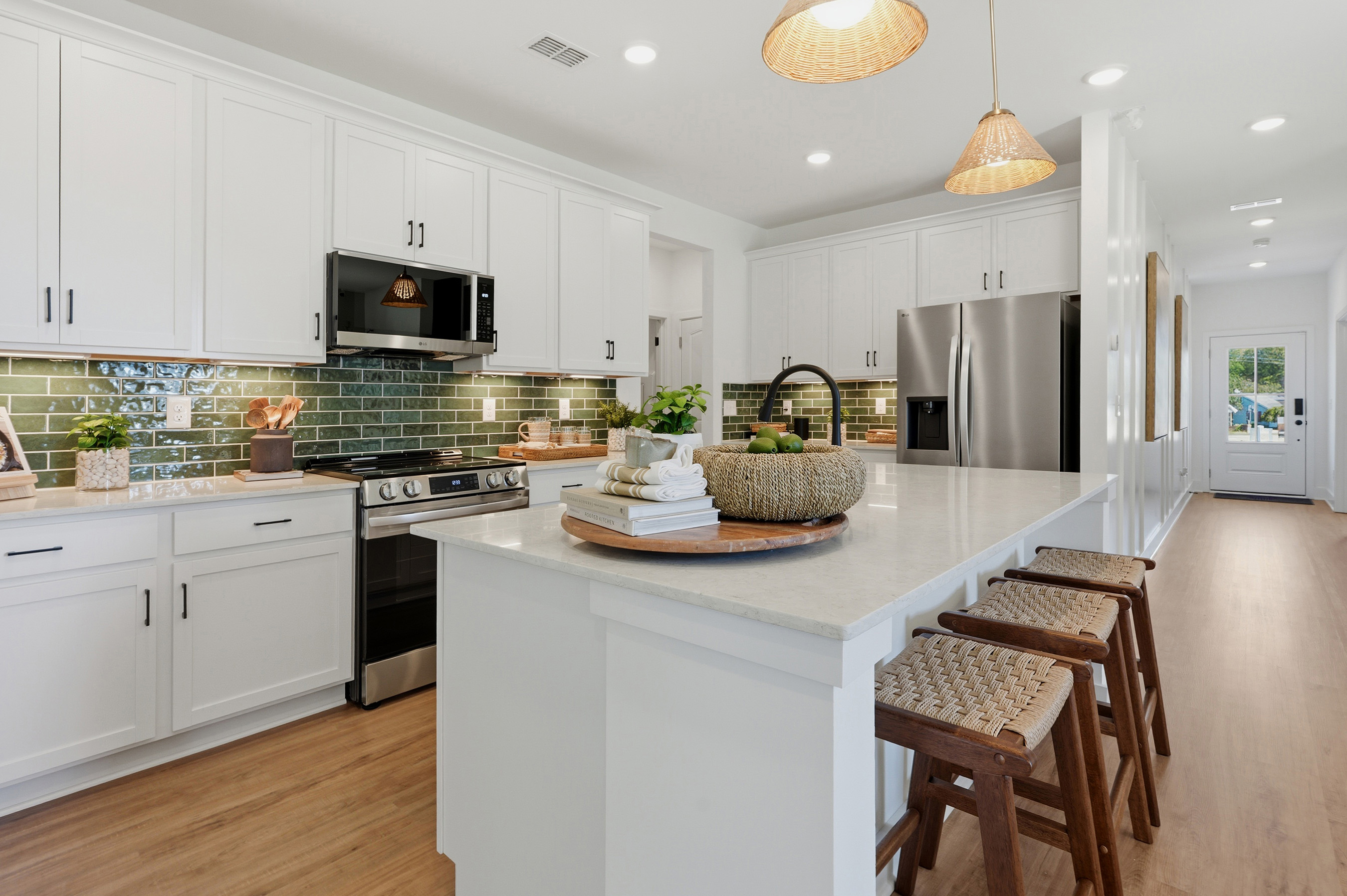 A kitchen with white cabinets.