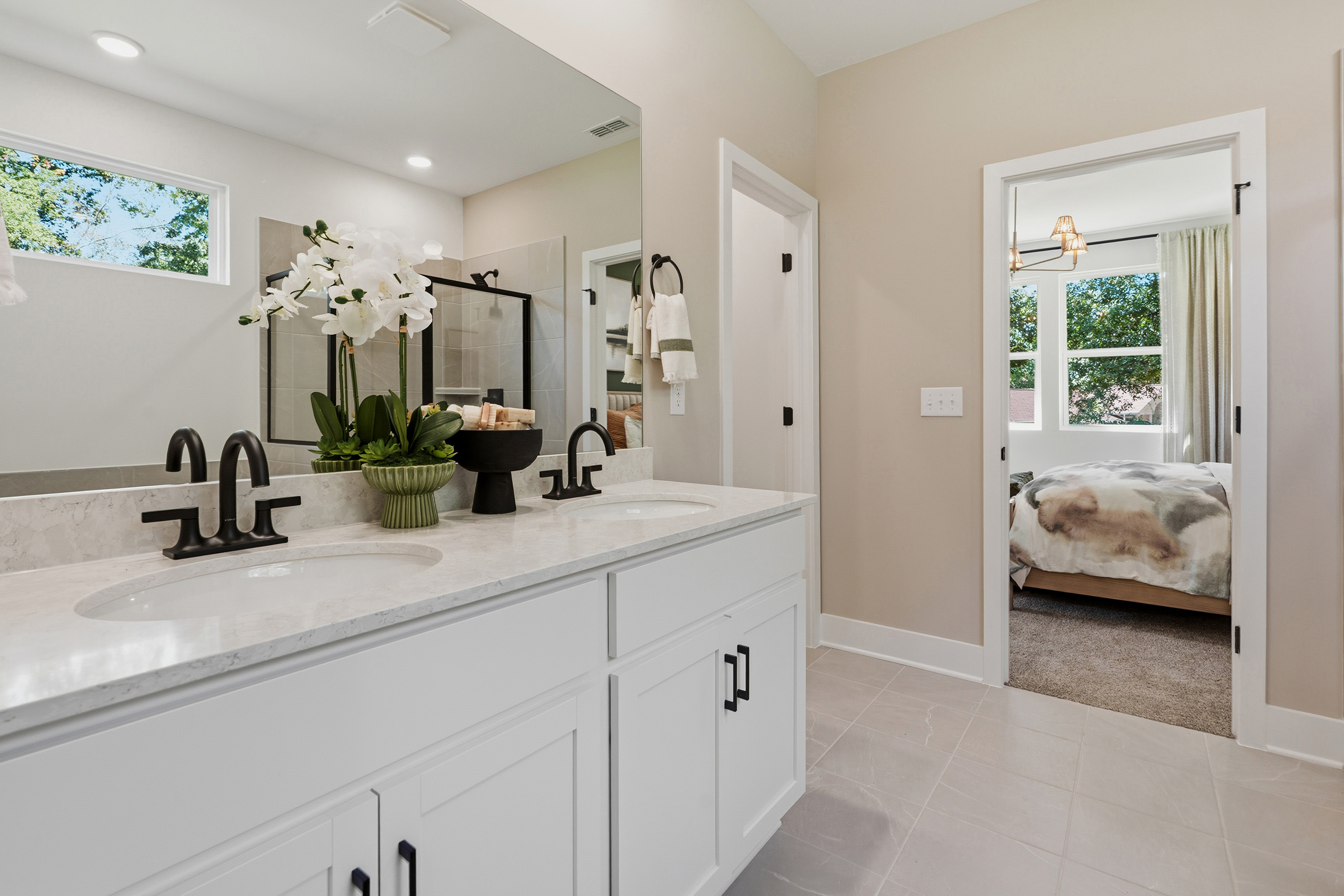 A bathroom with a sink and a bed.