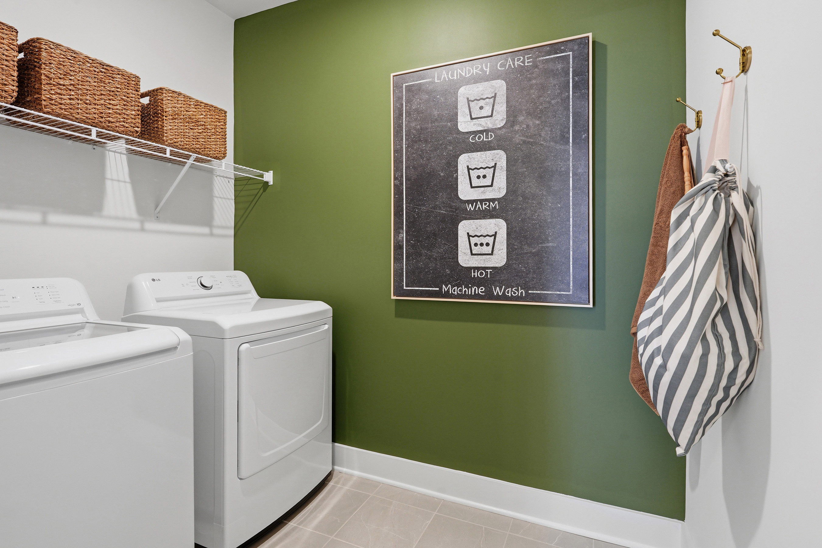 A green chalkboard with a towel on a wall.