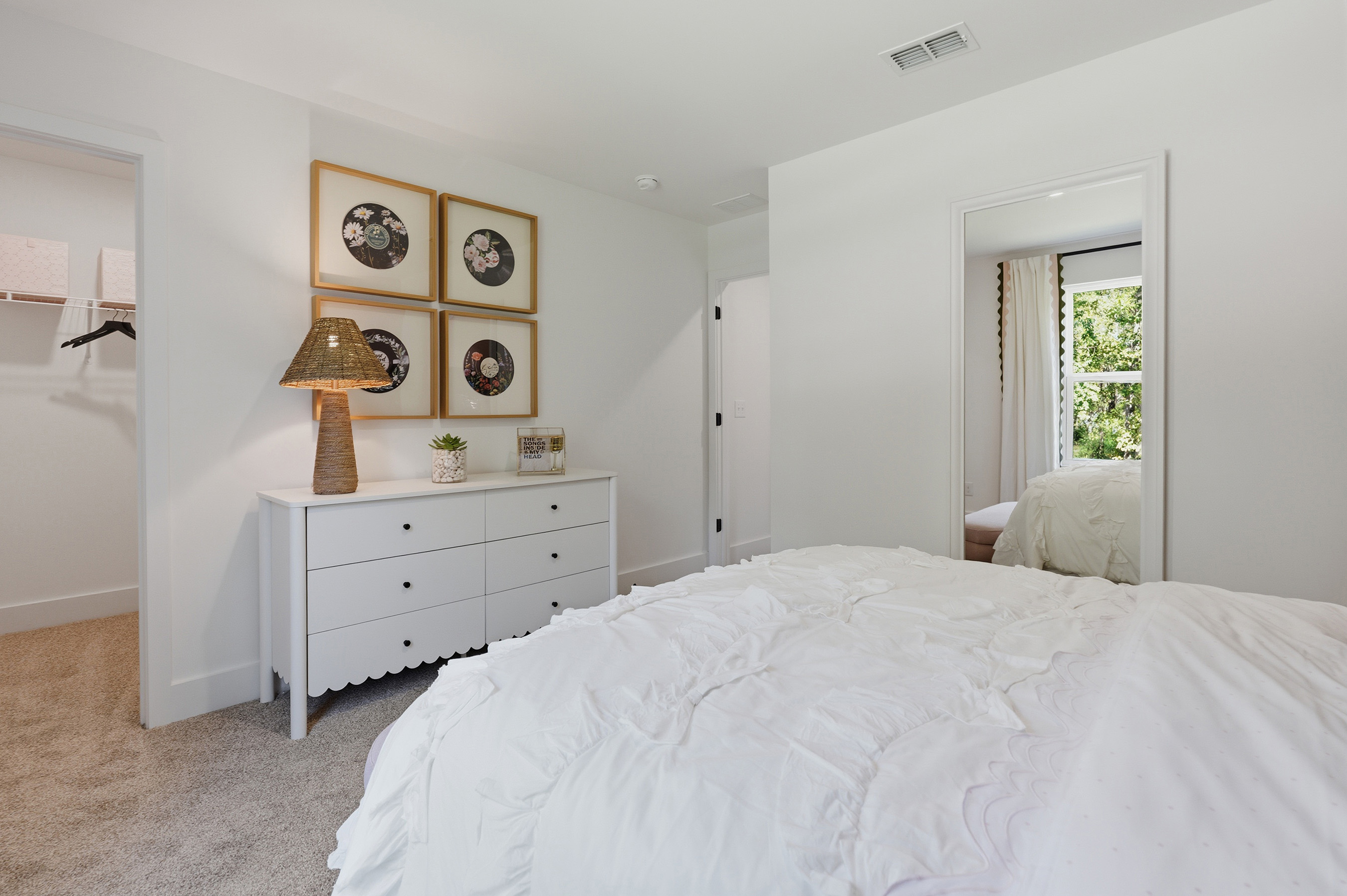 A bedroom with a bed and a lamp.