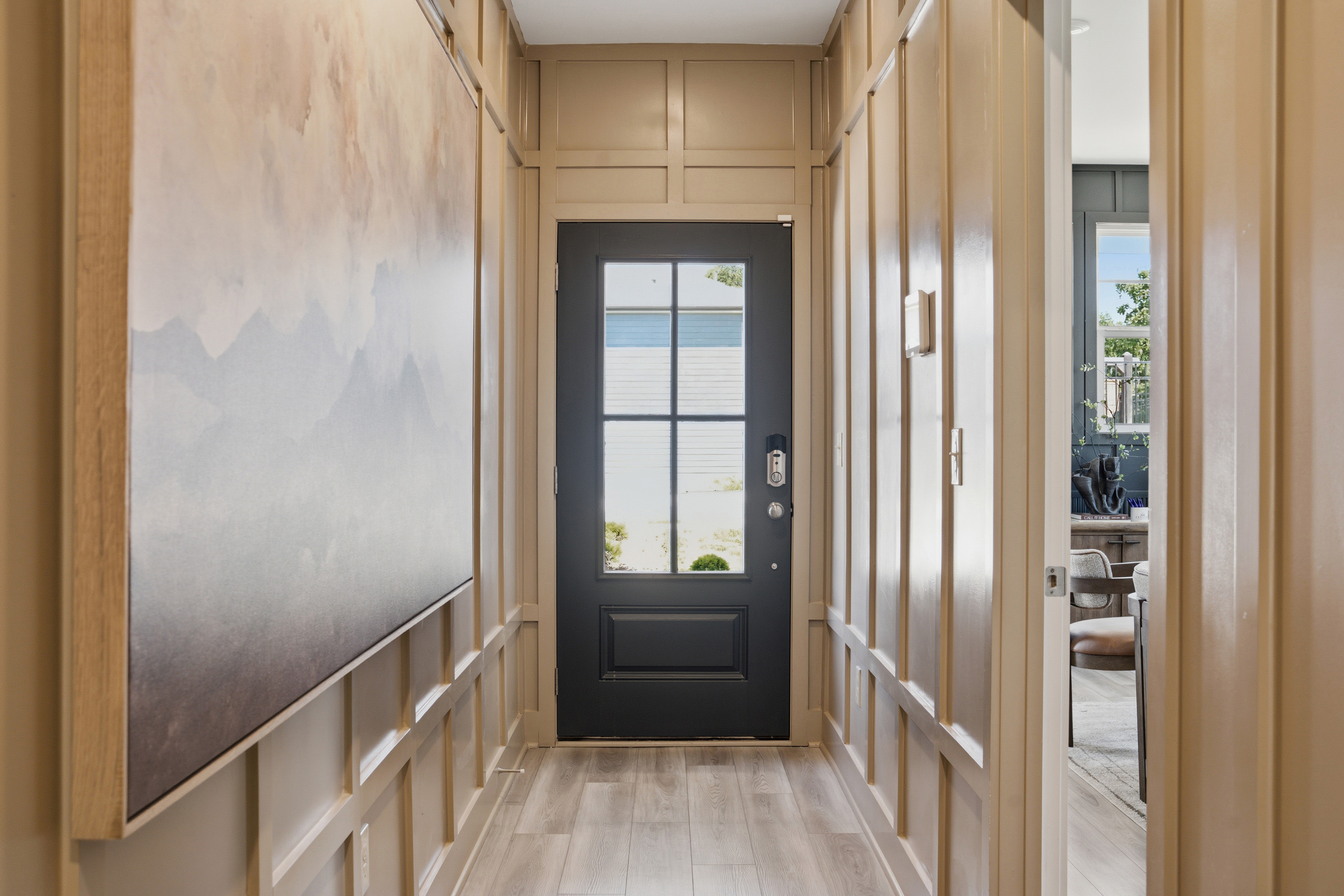A hallway with a door and a window.