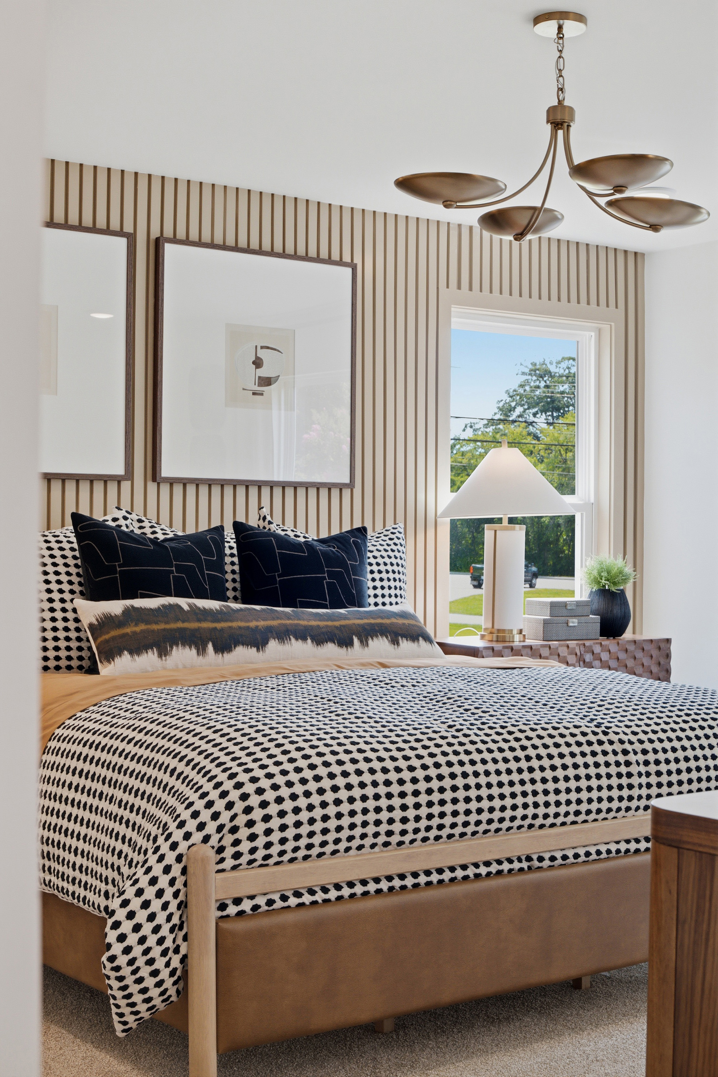 A bed with a mirror above it.