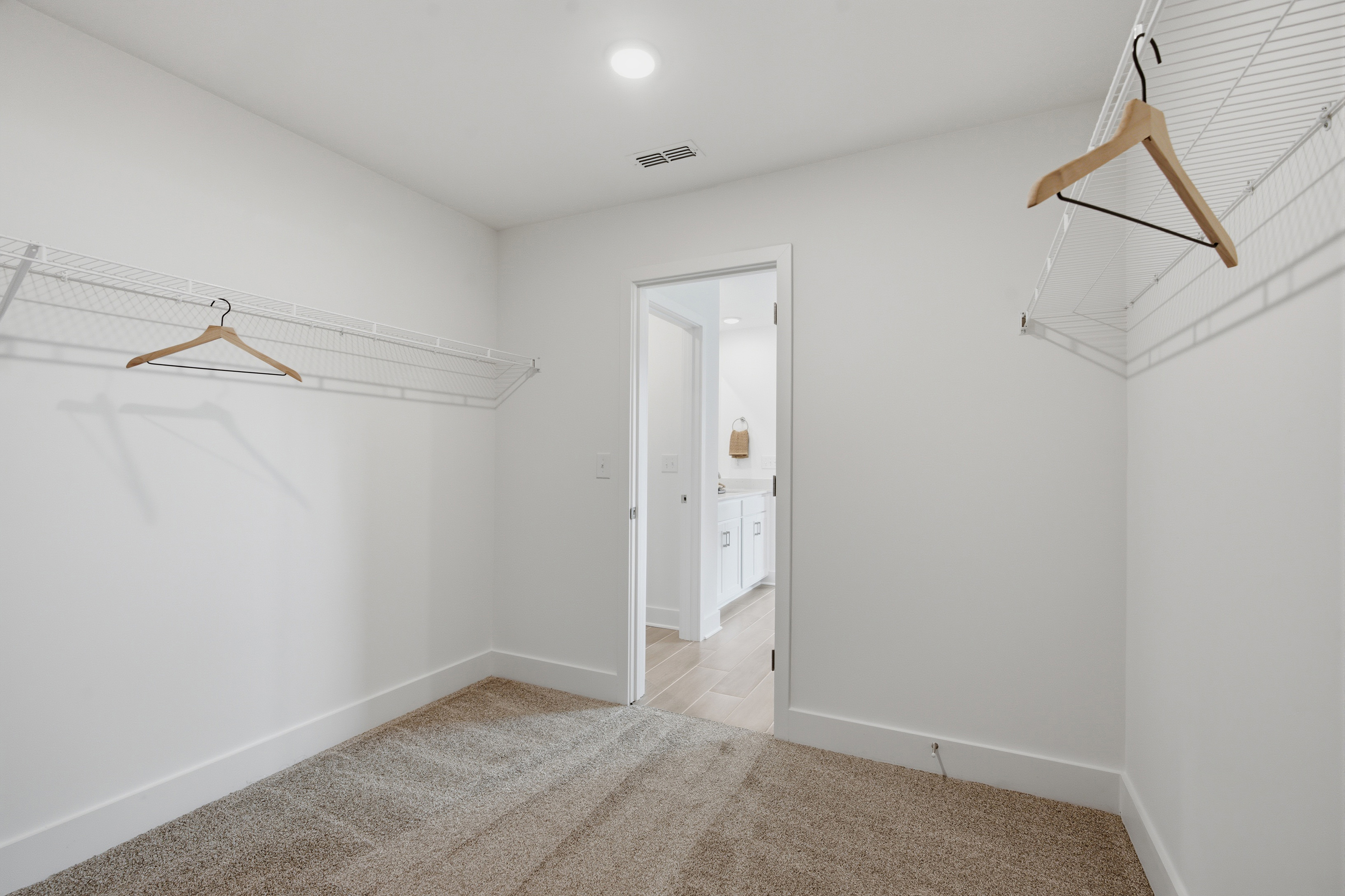 A hallway with white walls.