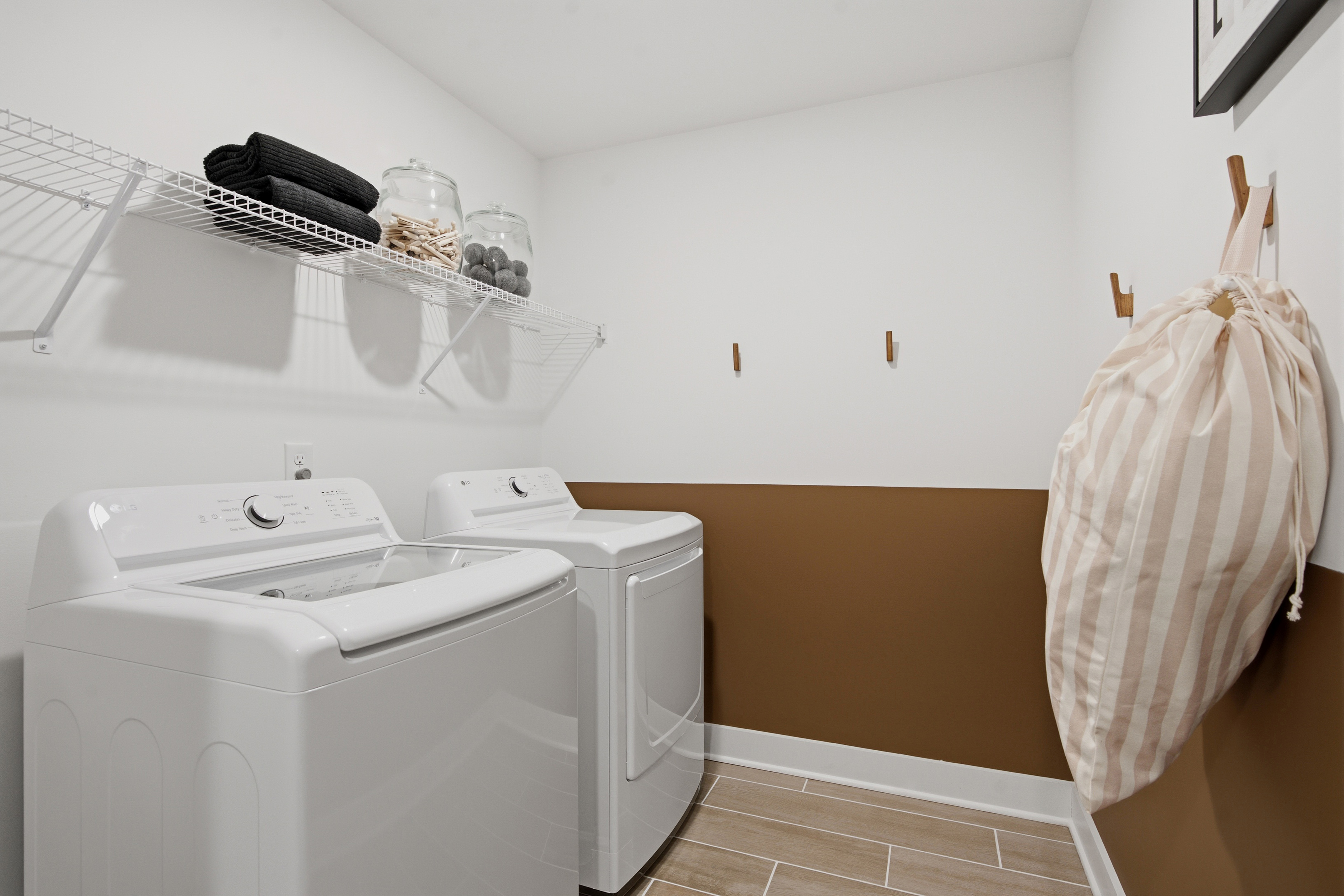 A laundry room with a washing machine.