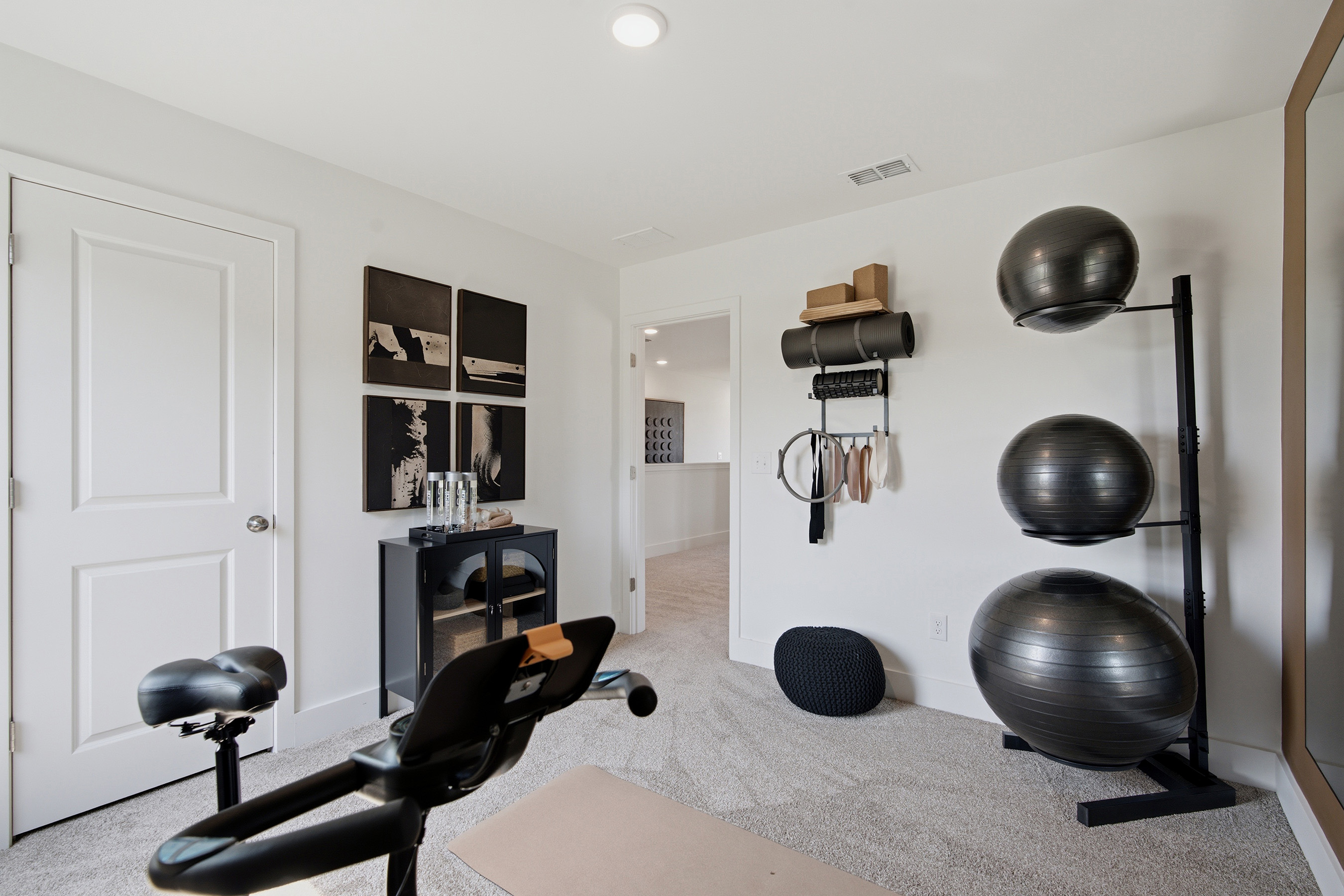 A room with a chair and a table with objects on it.