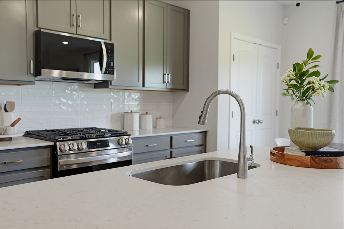 A kitchen with white cabinets.
