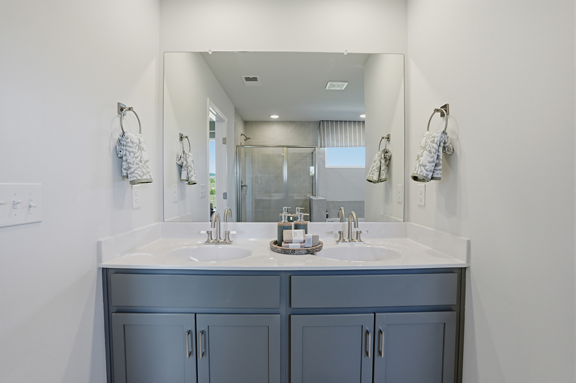 A bathroom with a large mirror.