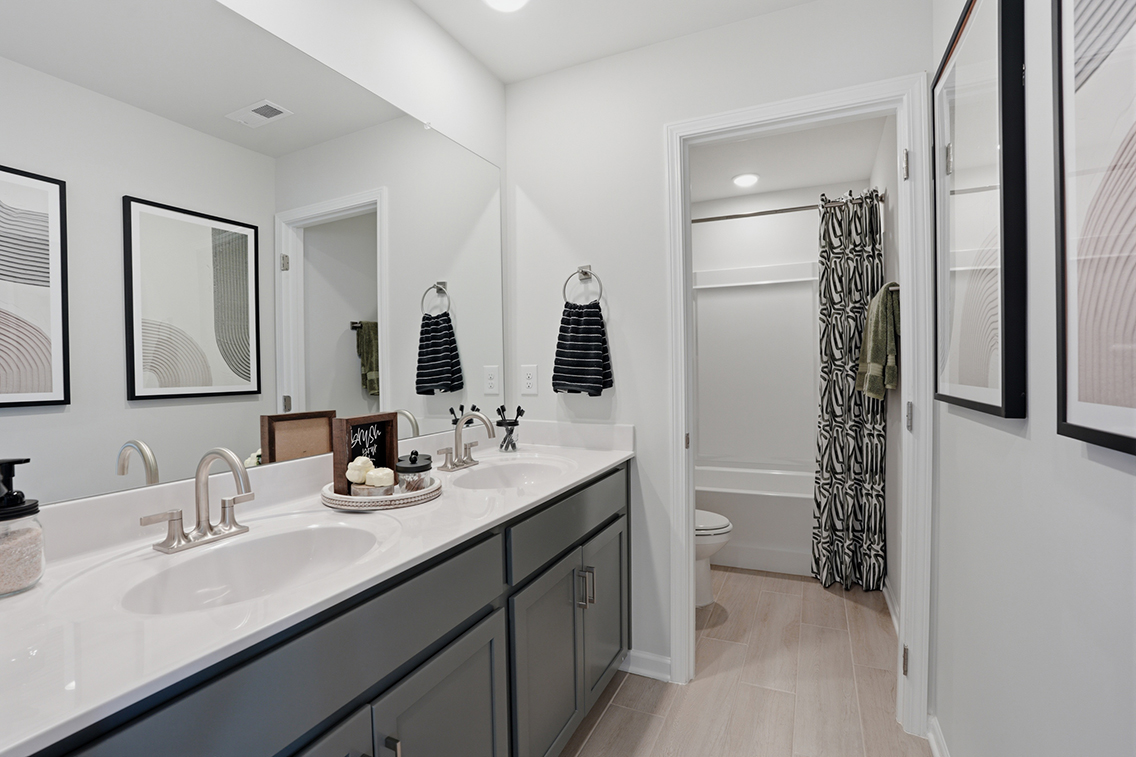 A bathroom with a sink and a shower.