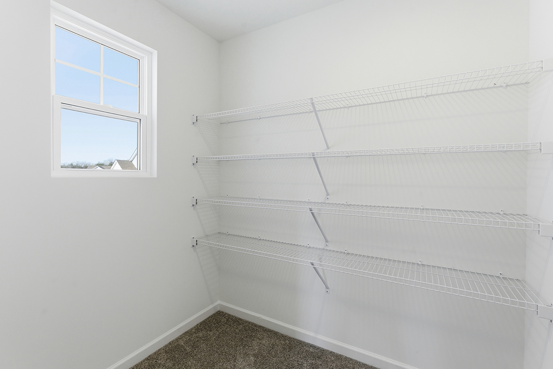 A white wall with a window.