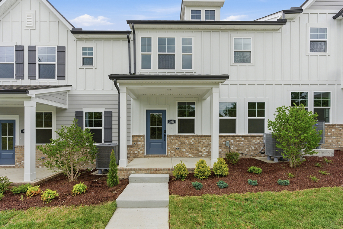 A white building with a blue door.