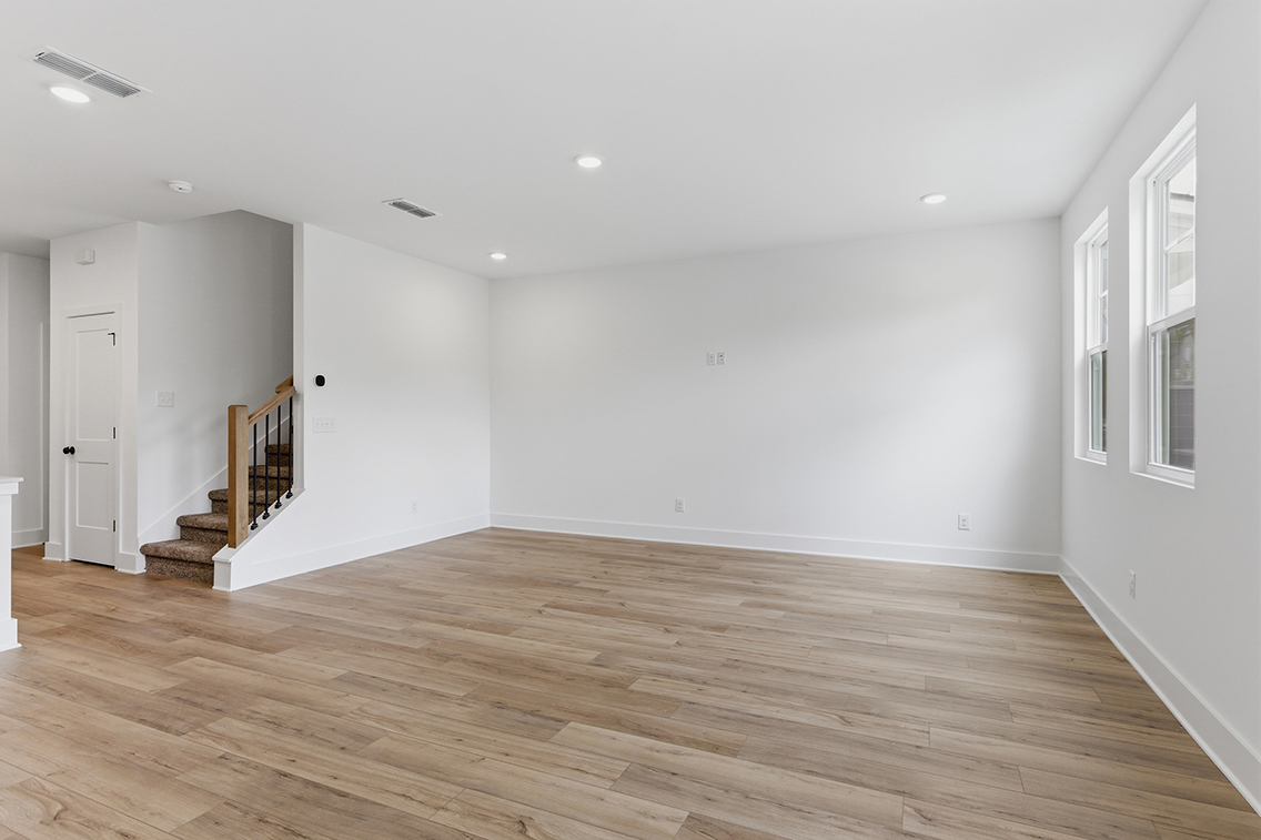 A room with a wood floor and white walls.