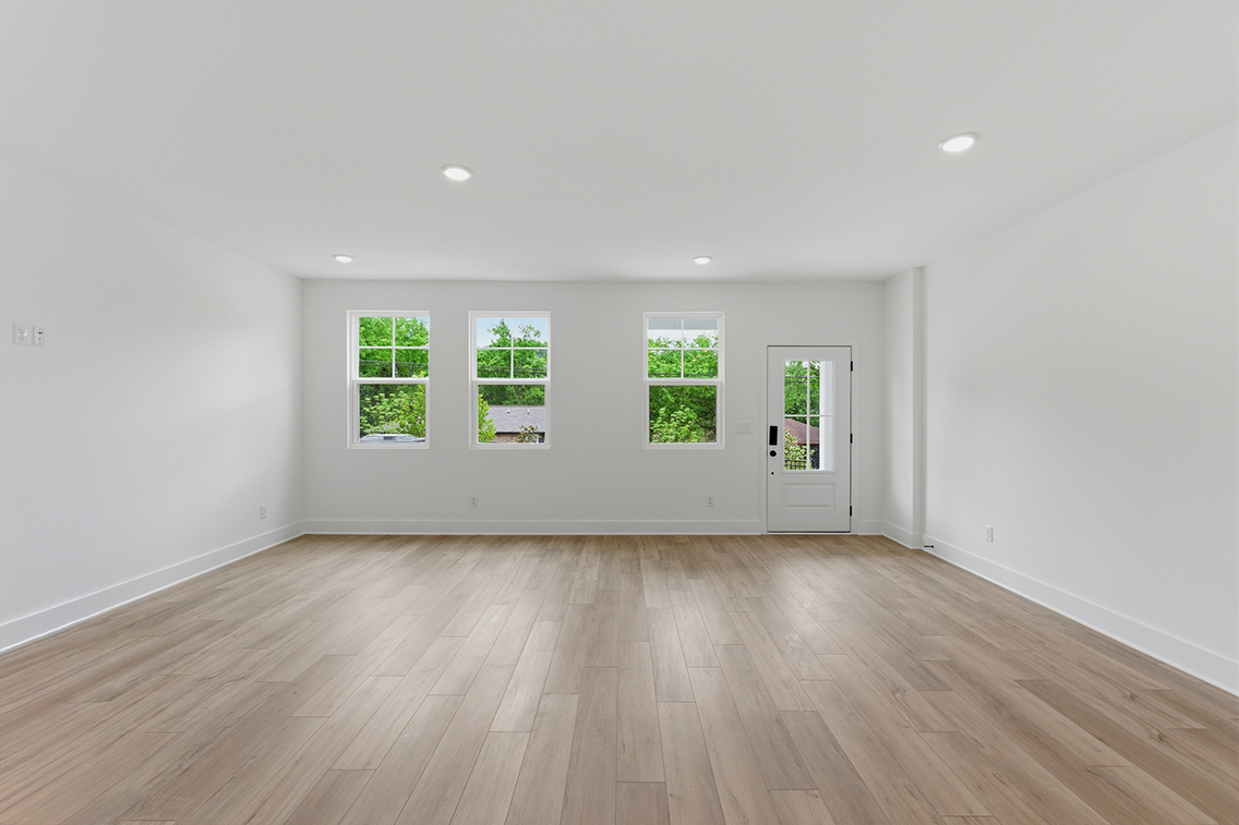 A room with a wood floor and white walls.