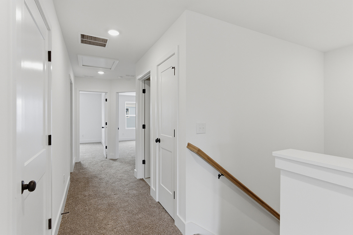 A hallway with white doors.