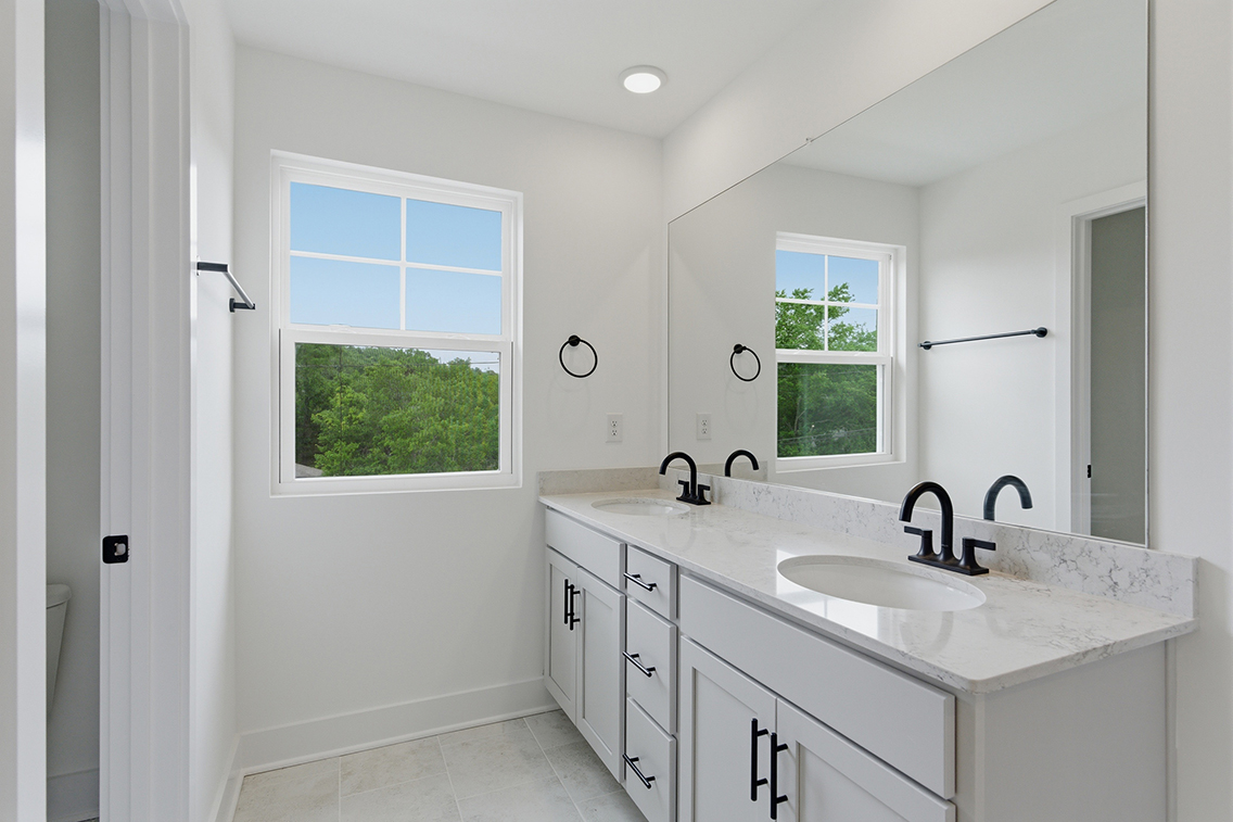 A bathroom with a sink and a mirror.