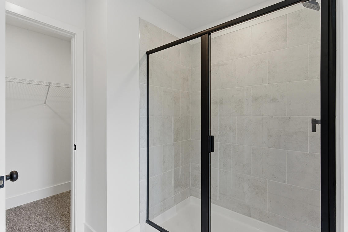 A shower with a glass door.