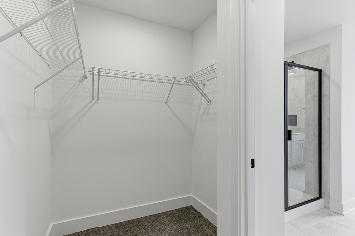 A white staircase with a glass door.