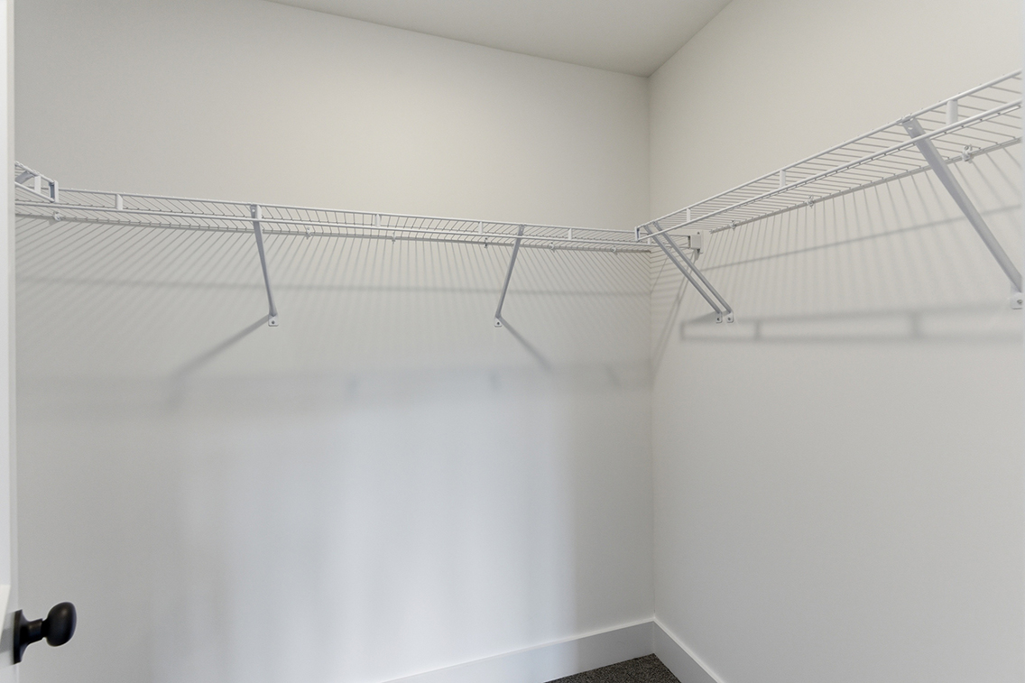 A white wall with a metal railing.