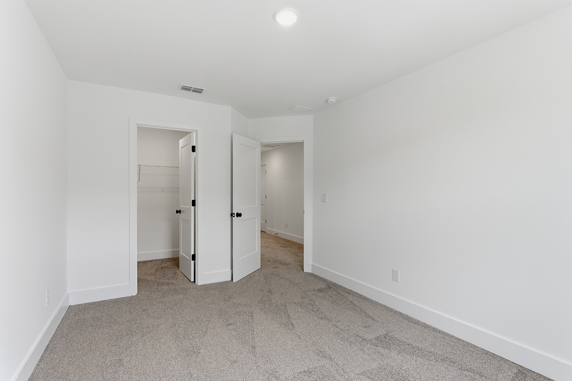 A hallway with white walls.