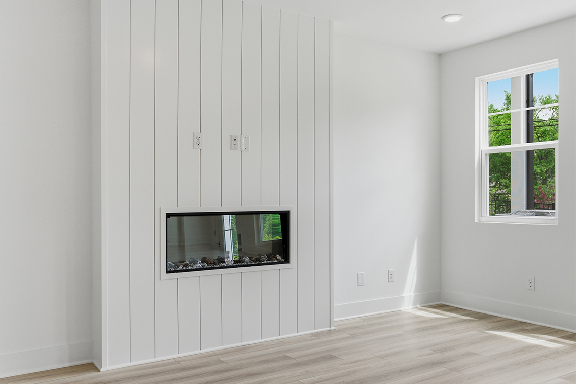 A room with a tv and a window.