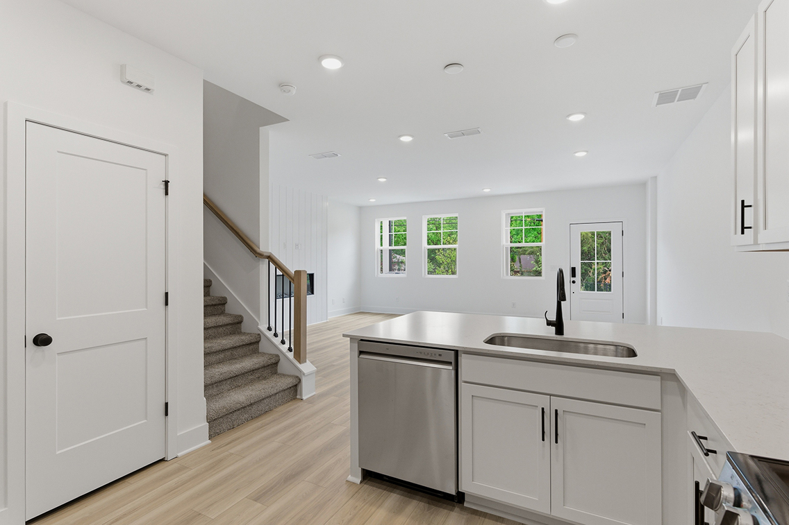 A kitchen with white cabinets.