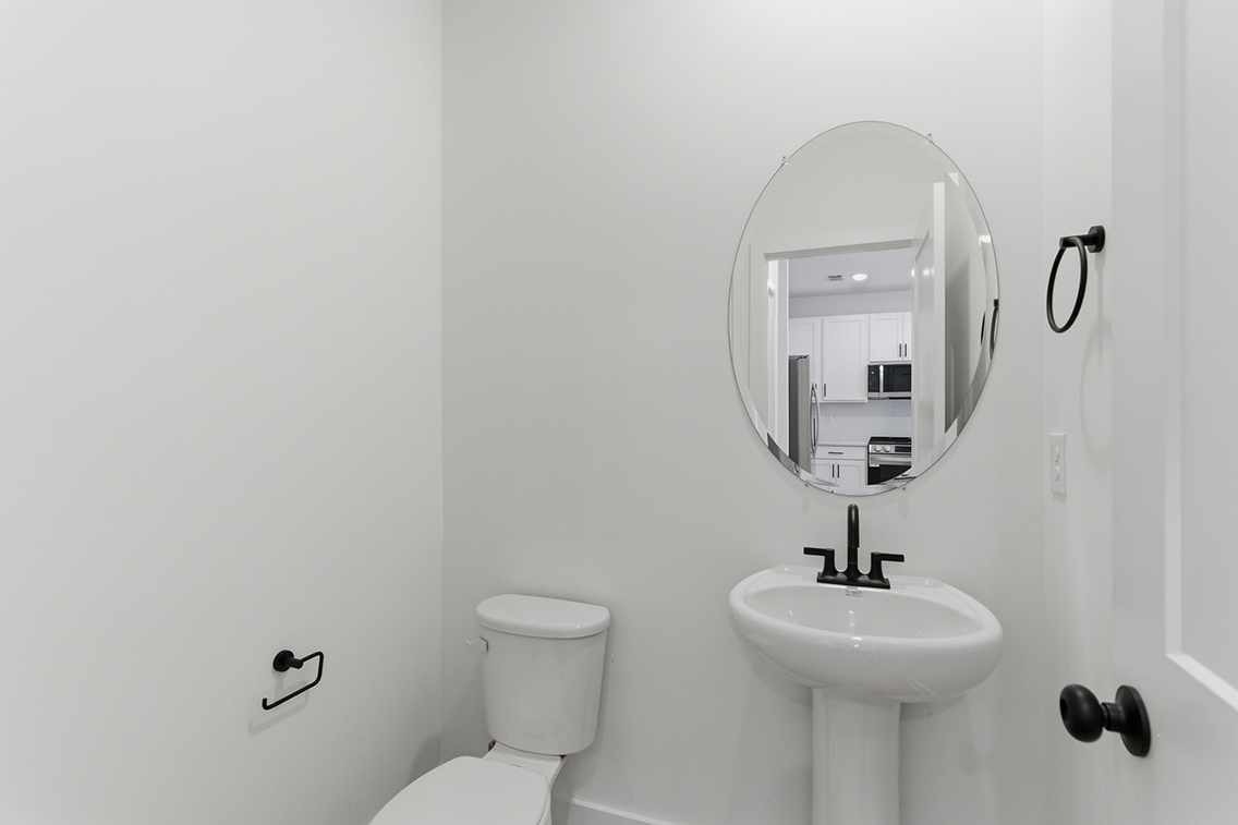 A bathroom with a mirror and sink.