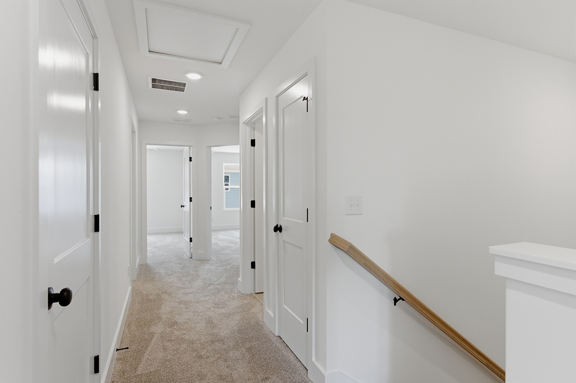 A hallway with white doors.