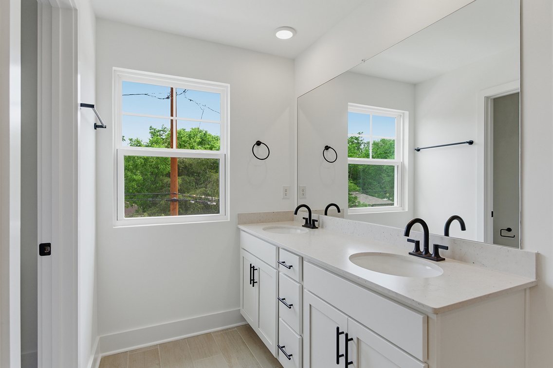 A bathroom with a sink and a window.
