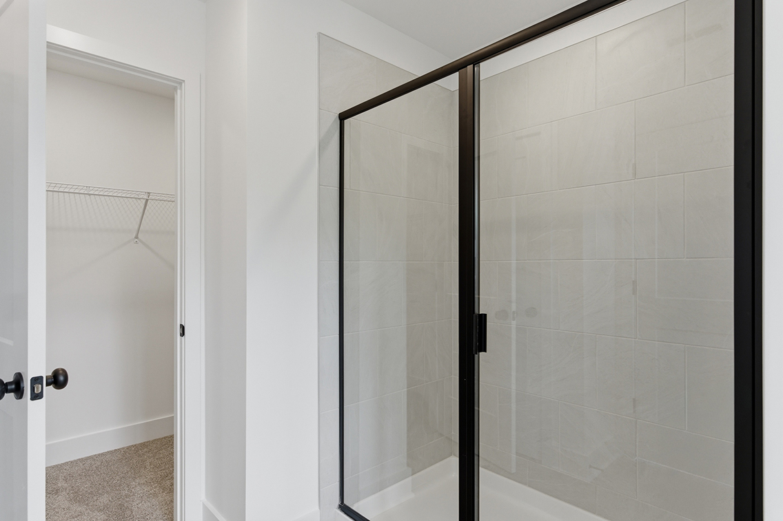 A shower with a glass door.