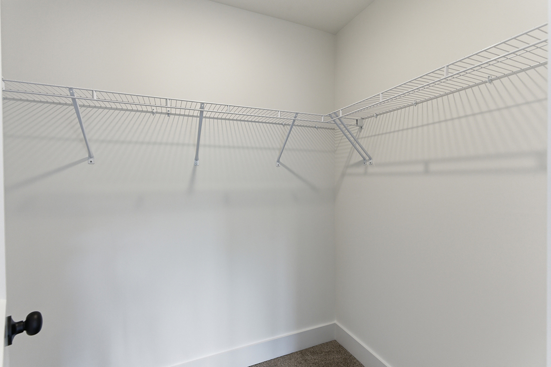 A white wall with a metal railing.