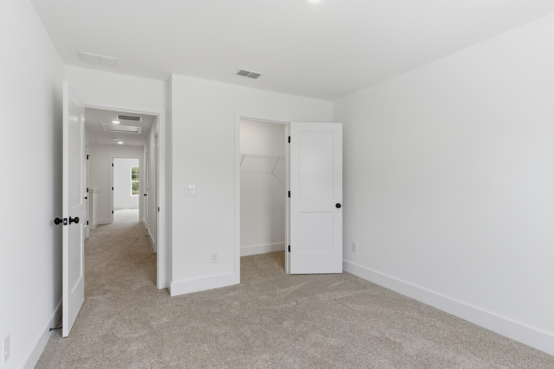 A hallway with white doors.