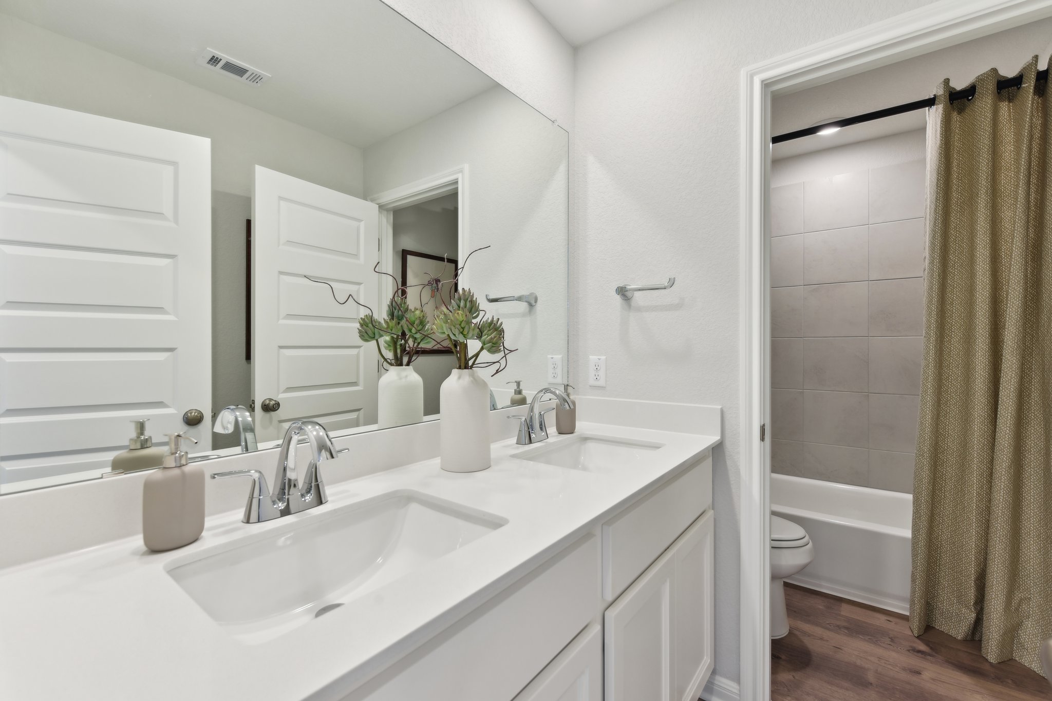 A bathroom with a sink toilet and a bathtub.